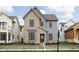 Charming two-story home featuring a brick and gray siding facade and professionally landscaped front yard at 1659 Midland Main St, Westfield, IN 46074