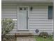 Close-up of a white front door with sidelights and a security system sign, set against light-colored siding at 9634 Maple Dr, Carmel, IN 46280