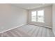 Neutral bedroom featuring carpeted floors and a large window allowing for plenty of natural light at 1099 Gatewick Ct, Greenwood, IN 46143