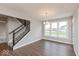 Bright dining area with a modern chandelier, large windows, and staircase at 1099 Gatewick Ct, Greenwood, IN 46143