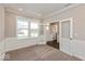 Cozy home office featuring wainscoting, neutral paint and large windows for natural light at 1099 Gatewick Ct, Greenwood, IN 46143