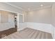 Well-lit office space with wainscoting, carpeted floors and glass paneled door at 1099 Gatewick Ct, Greenwood, IN 46143