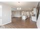 Open-concept living room flows into a modern kitchen with hardwood floors and neutral paint at 1099 Gatewick Ct, Greenwood, IN 46143