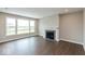 Cozy living room with a modern fireplace and large windows offering a scenic view at 1099 Gatewick Ct, Greenwood, IN 46143