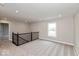 Upstairs loft area with carpet flooring, black metal railing, and natural light at 1099 Gatewick Ct, Greenwood, IN 46143