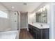 Main bathroom featuring double vanity, large mirror and shower with seat at 1099 Gatewick Ct, Greenwood, IN 46143