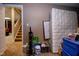 View of the basement storage with stairs and a hallway leading to a carpeted living area at 5964 Laramie Trl, Columbus, IN 47203