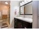 Bathroom featuring a dark wood vanity with brushed nickel faucet and framed mirror at 5964 Laramie Trl, Columbus, IN 47203