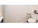 A clean bathroom featuring a toilet and modern sink with a small storage cabinet at 5964 Laramie Trl, Columbus, IN 47203