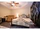 Spacious bedroom featuring a ceiling fan, neutral walls, and decorative curtains at 5964 Laramie Trl, Columbus, IN 47203