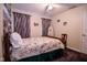 Bedroom featuring a ceiling fan, decorative curtains, and a floral comforter at 5964 Laramie Trl, Columbus, IN 47203