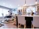 Charming kitchen featuring white cabinets, a breakfast bar with seating, and stainless steel appliances at 5964 Laramie Trl, Columbus, IN 47203