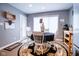 Bright eat-in kitchen with stainless steel appliances and a round dining table with a floral rug at 5964 Laramie Trl, Columbus, IN 47203