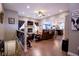 Open-concept living room featuring hardwood floors, a cozy fireplace, and a seamless connection to the kitchen at 5964 Laramie Trl, Columbus, IN 47203