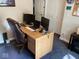 Functional home office with a large desk, comfortable chair, and ample space for multiple monitors at 5964 Laramie Trl, Columbus, IN 47203