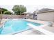Backyard pool with diving board, cabana, and patio provides the perfect space for outdoor entertainment at 5964 Laramie Trl, Columbus, IN 47203