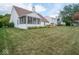 Expansive backyard with a well-manicured lawn, screened in porch, and lush landscaping at 7119 Topp Creek Ct, Indianapolis, IN 46214
