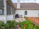 Backyard view featuring a wooden deck, barbecue grill, garden, flower beds and screened in porch at 7119 Topp Creek Ct, Indianapolis, IN 46214