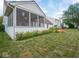 Landscaped backyard with a wooden deck and screened-in porch at 7119 Topp Creek Ct, Indianapolis, IN 46214