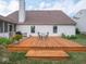 Backyard wooden deck with a seating area and BBQ grill, and flowers at 7119 Topp Creek Ct, Indianapolis, IN 46214