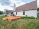 Home's backyard showing a wooden deck, a barbeque grill, a garden and a screened-in porch at 7119 Topp Creek Ct, Indianapolis, IN 46214