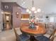The dining area features a chandelier and a round wooden table with chairs, creating a cozy atmosphere at 7119 Topp Creek Ct, Indianapolis, IN 46214