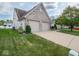 Brick home with attached two-car garage, green lawn and nice landscaping at 7119 Topp Creek Ct, Indianapolis, IN 46214