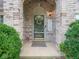 Inviting front porch with decorative glass door and green shrubs at 7119 Topp Creek Ct, Indianapolis, IN 46214