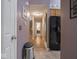 The hallway provides seamless access to the kitchen and the stairway and displays neutral wall colors at 7119 Topp Creek Ct, Indianapolis, IN 46214