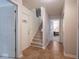 Inviting hallway showcasing carpeted stairs and easy access to multiple rooms and entryways at 7119 Topp Creek Ct, Indianapolis, IN 46214