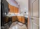 The eat-in kitchen is equipped with stainless steel appliances, wooden cabinets and a tile floor at 7119 Topp Creek Ct, Indianapolis, IN 46214