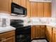 Well-lit kitchen features updated appliances and wooden cabinetry for a warm and inviting cooking space at 7119 Topp Creek Ct, Indianapolis, IN 46214