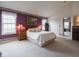 Large main bedroom with a vaulted ceiling, carpet, purple accent wall and bright window at 7119 Topp Creek Ct, Indianapolis, IN 46214