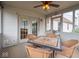 Cozy sun room with a ceiling fan and a table surrounded by four wicker chairs with plush cushions at 7119 Topp Creek Ct, Indianapolis, IN 46214
