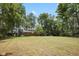 Spacious backyard with lush green grass and mature trees at 236 Bixler Rd, Indianapolis, IN 46227