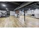 Finished basement featuring laminate floors, a finished ceiling, and areas for both recreation and laundry at 236 Bixler Rd, Indianapolis, IN 46227