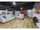 Comfortable finished basement with a brick fireplace, laminate floors, and a relaxing seating area at 236 Bixler Rd, Indianapolis, IN 46227