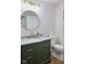 Stylish bathroom with a round mirror, modern vanity and gold fixtures at 236 Bixler Rd, Indianapolis, IN 46227