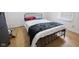 Cozy bedroom with hardwood floors and a comfortable-looking bed at 236 Bixler Rd, Indianapolis, IN 46227