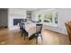 Inviting dining area featuring hardwood floors, a large window, and a fireplace at 236 Bixler Rd, Indianapolis, IN 46227