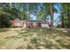 Charming red brick home with attached garage and a well-maintained yard surrounded by mature trees at 236 Bixler Rd, Indianapolis, IN 46227