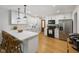 Modern kitchen with white cabinets, stainless steel appliances, quartz countertops, and hardwood floors at 236 Bixler Rd, Indianapolis, IN 46227