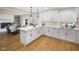 Bright kitchen featuring white cabinetry, stainless steel appliances, an island, and access to the dining area at 236 Bixler Rd, Indianapolis, IN 46227