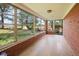 Enclosed sun room with brick walls, large windows, and hardwood floors, providing a bright and airy space at 236 Bixler Rd, Indianapolis, IN 46227