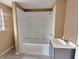 Bathroom with tub, shower, and gray vanity at 1011 S Elm St, Muncie, IN 47302