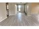 Open dining area with grey wood-look floors and staircase at 1011 S Elm St, Muncie, IN 47302