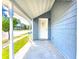 Inviting front porch with white door and grey siding at 1011 S Elm St, Muncie, IN 47302