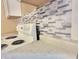 Close-up of the kitchen's mosaic backsplash and stove at 1011 S Elm St, Muncie, IN 47302