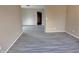 Bright living room featuring grey wood-look flooring at 1011 S Elm St, Muncie, IN 47302