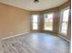 Living room with bay windows and grey wood-look floors at 1011 S Elm St, Muncie, IN 47302